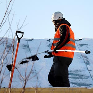 Someone Scraping Snow off of roof - Click to Learn More